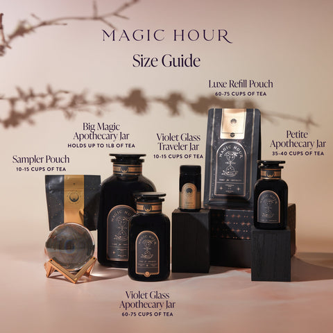 An arrangement of various black and gold Magic Hour tea containers under a branch's shadow. The containers, filled with Aquamarine Dream - Soothing Herbal Ayurvedic Adrenal Tonic, are labeled: Luxe Refill Pouch, Big Magic Apothecary Jar, Violet Glass Traveler Jar, Violet Glass Apothecary Jar, Petite Apothecary Jar, and Sampler Pouch. The text reads "Magic Hour Tea Size Guide.