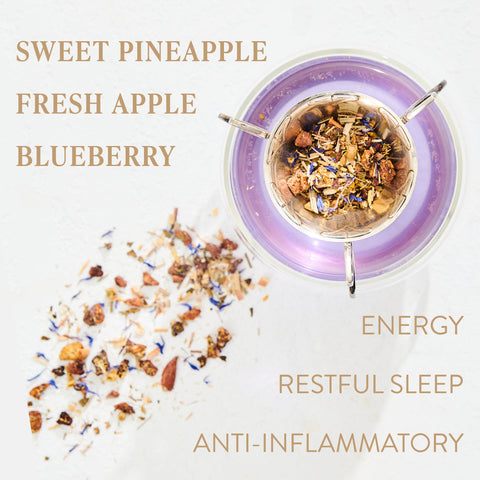 A top-down view of a tea blend in a purple-rimmed infuser, with scattered dried ingredients including pieces of pineapple, apple, and blueberries. Text labels read: "Magic Hour Aquamarine Dream - Soothing Herbal Ayurvedic Adrenal Tonic, Sweet Pineapple, Fresh Apple, Blueberry, Energy, Restful Sleep, Anti-Inflammatory.