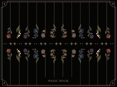 A black background features a symmetrical pattern of stylized flowers and leaves in red, blue, purple, and beige hues. Eight vertical lines form the pattern, with "MAGIC HOUR" written at the bottom. Small stars are scattered around the design. Perfect for your organic tea ritual with our Tea Ceremony Towels.