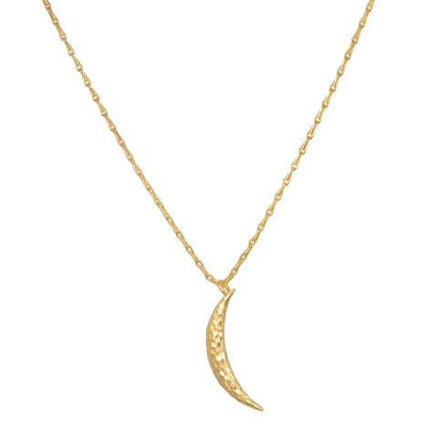 The Midnight Sky Pendant Moon Necklace showcases a delicate gold design with a thin, textured crescent moon pendant. The fine and simple chain elegantly complements the shiny, hammered 18kt gold finish of the moon charm. This necklace boasts a lightweight and minimalist design that subtly captures the essence of the celestial realm.