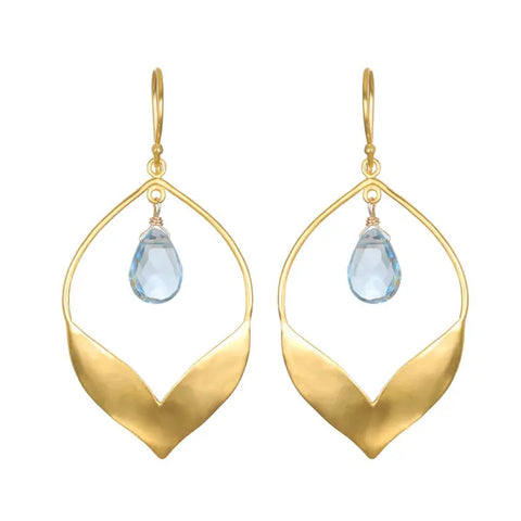 Introducing the Spring Lotus Earrings, a stunning pair of 18kt gold-plated drop earrings showcasing a leaf-like open design with a teardrop-shaped blue topaz gemstone elegantly suspended in the center of each.