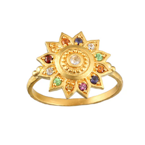 A Magic Hour Vibrant Self Multi Stone Lotus Ring crafted in 18kt gold-plated finish featuring a round center stone surrounded by intricately detailed triangular petals embedded with healing gemstones in green, red, blue, and clear. The polished, ornate design beautifully resembles a blooming flower.