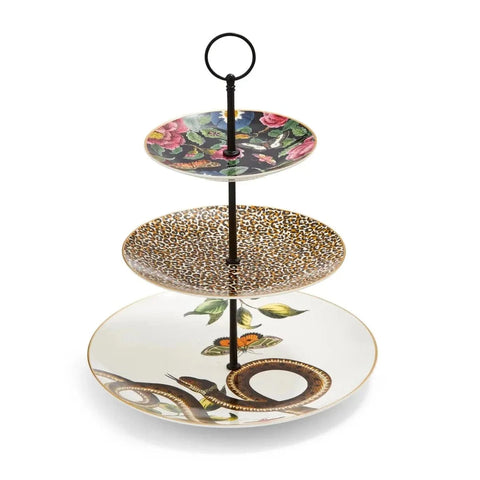 Introducing the Creatures of Curiosity - Tea Ceremony Cake Stand: a stylish serving piece featuring a sleek black central pillar and an elegant round handle at the top. The top plate showcases the Creatures of Curiosity signature floral pattern, while the middle plate boasts a striking leopard print design. The bottom plate is adorned with detailed illustrations of snakes and butterflies.