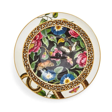 The Creatures of Curiosity - Tea Ceremony Cake Stand is a fashionable piece adorned with a vibrant floral pattern showcasing roses, morning glories, and other colorful flowers alongside butterflies. The border flaunts bold patterns featuring a leopard print and a gold snake design that encircles the floral center, perfectly embodying the essence of the Creatures of Curiosity collection.