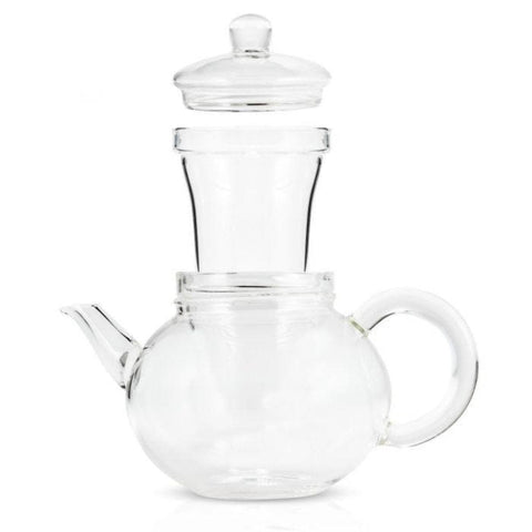 The Hand Blown 32oz Glass Teapot with Infuser is made from heat-resistant borosilicate glass and includes an infusion chamber and lid. Its rounded body features a spout on the left side and a handle on the right, with a removable glass infuser basket sitting inside its top opening. The teapot is currently empty.